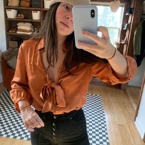 Burnt orange silky blouse with tie at neck